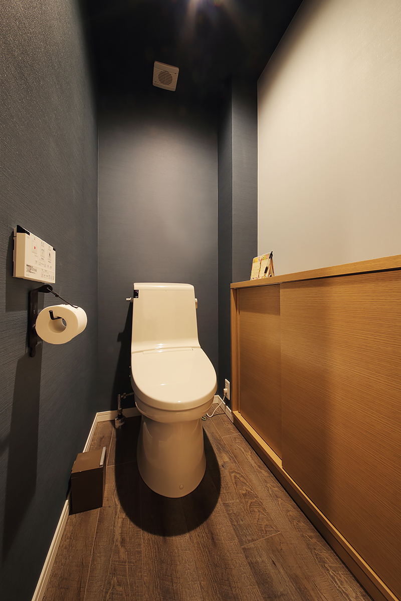 濃淡の異なる同系色クロスでまとめたトイレはシックな雰囲気。
